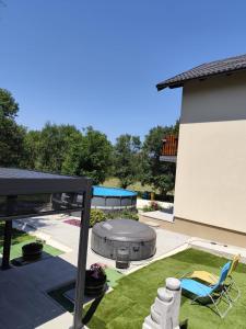 a backyard with a fire pit and a patio at Apartment Topalovic Plitvice Private Pool in Korenica