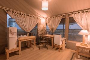 a room with two tables and chairs in a tent at Mara Maisha Camp in Talek
