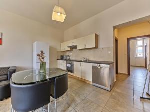 a kitchen with a table and chairs in a room at Teplice Apartments U Schodů in Teplice +5 photos