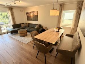 a living room with a table and a couch at Gimmeldinger Haus in Neustadt an der Weinstraße