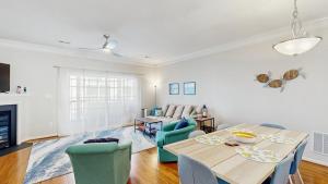 a living room with a table and chairs and a couch at Rehoboth Crossing --- 19913 Ames Drive #106 in Rehoboth Beach