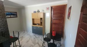 a kitchen with a table and chairs in a room at Loft urbano in Martins +1 photo