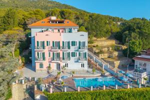 an aerial view of a large pink house with an orange roof at Seaview Pool Retreat - Il Poggio in Marina di Andora