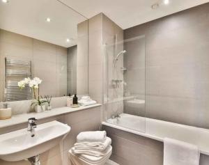a bathroom with a sink and a shower and a tub at Allen Home in Bang Bua Thong Railway Station