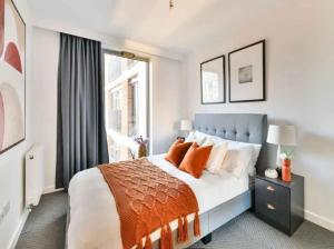 a bedroom with a large bed and a window at Allen Home in Bang Bua Thong Railway Station
