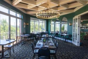 a restaurant with tables and chairs and a chandelier at Wyndham Garden Madison Fitchburg in Madison