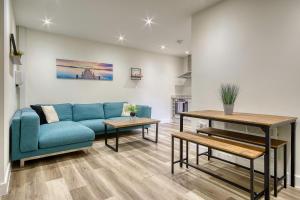 a living room with a blue couch and a table at The Studio Castle Lane in Bournemouth