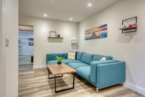 a living room with a blue couch and a table at The Studio Castle Lane in Bournemouth +16 photos