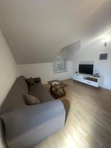 a living room with a couch and a table at Amra in Počitelj