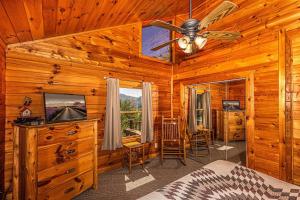 a bedroom with a bed and a ceiling fan at Shooting Star Ridge in Whittier
