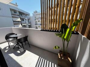 a balcony with a table and a plant on it at Elegance Suites in Pyrgos