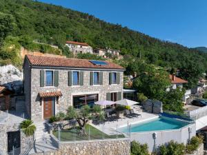 a villa with a swimming pool and a house at Vila Marigold in Opatija