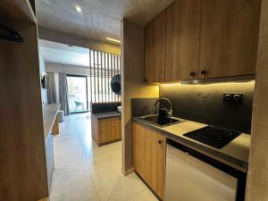 a kitchen with a sink and a stove top oven at Elegance Suites in Pyrgos