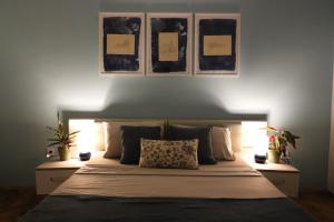 a bedroom with a bed with three pictures on the wall at Bonaca Room in Donja Lastva