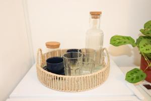 a bottle and glasses in a basket on a shelf at Bonaca Room in Donja Lastva