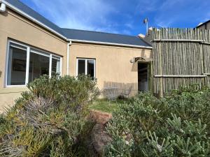 a house with bushes in front of it at The Annex in Pringle Bay