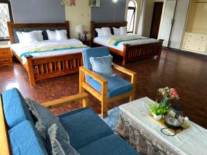 a living room with two beds and a couch at Ilemi Gardens in Nairobi
