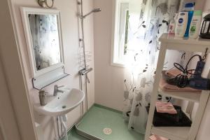 a small bathroom with a sink and a mirror at Cozy Smalandcottage Alsterfors 23 - towels, bed linen and toiletries provided - in Alsterfors +35 photos