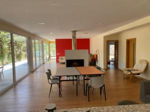 a living room with a table and chairs and a fireplace at Vale Do Gavim, Moitas in Trancoso