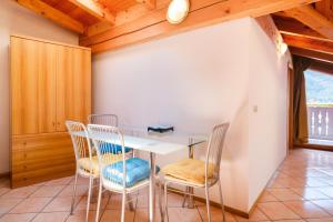 a dining room with a table and chairs at Residenza Garibaldi - Cirmolo in Molveno +9 photos