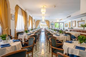 a row of tables and chairs in a restaurant at Hotel Montana in Massa Lubrense