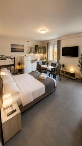 a large bedroom with a large bed and a living room at Rubiera Residence - H24 in Zimella