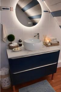 a bathroom with a sink and a mirror at Chambres à l'écrin de bois in Guerlédan +17 photos