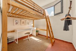 a room with a desk and a loft bed at Balili Surf House in Baleal