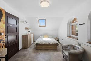 a bedroom with a bed and a chair at Vila v Lahošti in Teplice +44 photos