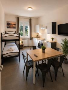 a living room with a table and a bunk bed at Rubiera Residence - H24 in Zimella