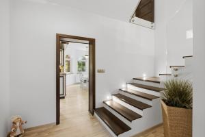 a hallway with stairs in a home with a mirror at Vila v Lahošti in Teplice