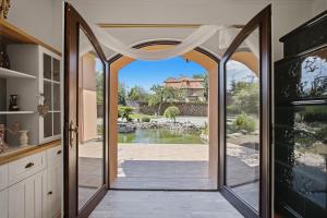 an open door to a patio with a view at Vila v Lahošti in Teplice