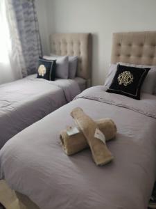 a stuffed animal is sitting on a bed at Dar hicham in Hajreien