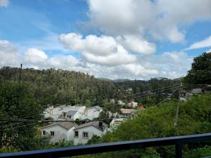 a view of a town with houses and trees at Goldan inn yercaud in Yercaud