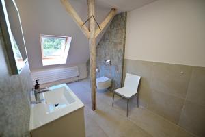 a bathroom with a sink and a toilet and a tree at FLH - Casa Cascada in Fîntînele +78 photos