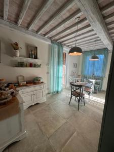 a kitchen with a table and a dining room at L’ Aia del Principe in Montepulciano