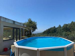 a large swimming pool on the side of a house at Vale Do Gavim, Moitas in Trancoso