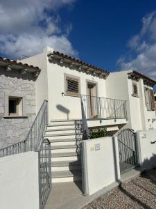 a white house with stairs and a fence at House Hermosa Barrabisa in Barrabisa