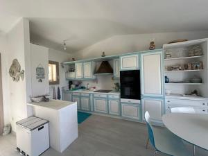 a kitchen with blue cabinets and a table in it at House Hermosa Barrabisa in Barrabisa +9 photos