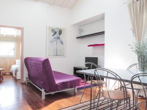 a living room with a purple couch and a table at Monte Girassol - The Lisbon Country House! in Quinta das Faias