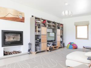 a living room with a fireplace and a tv at Monte Girassol - The Lisbon Country House! in Quinta das Faias