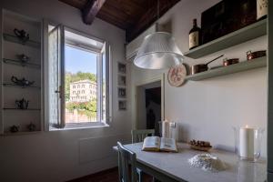 a dining room with a table and a window at Palazzo Benassi Penthouse nel cuore di Asolo in Asolo +57 photos