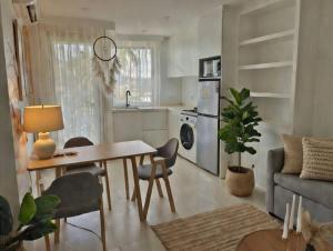 a kitchen and living room with a table and a couch at กิตติมา อพาร์ทเม้น in Nathon Bay