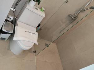 a bathroom with a toilet with a towel on it at กิตติมา อพาร์ทเม้น in Nathon Bay +4 photos