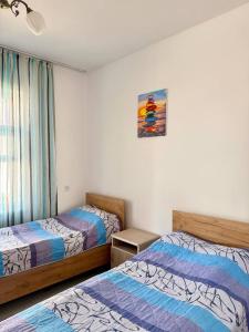 a bedroom with two beds and a window at Jibek Murok in Bosteri +37 photos