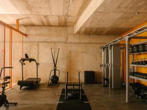 a gym with several exercise equipment in a room at RIVELIAN Grand Menorca in Menorca
