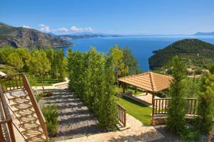 a garden with a view of the water at Villa Seliora in Sivota