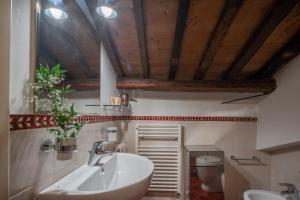 a bathroom with a sink and a toilet at Palazzo Benassi Penthouse nel cuore di Asolo in Asolo