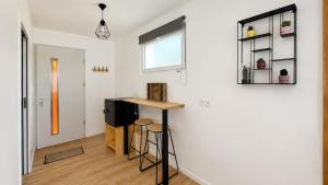 a small room with a table and stools in it at Beau Regard in Tournus