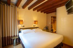 a bedroom with a white bed in a room at Ca' Dei Dogi in Venice